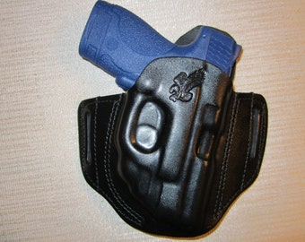 Smith and Wesson M&P Shield 9 mm y 40 cal. con protector láser CT rojo, funda de cinturón tipo panqueque OWB
