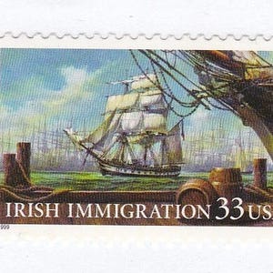 May include: A vintage US postage stamp depicting a sailing ship with white sails against a blue sky and water. The stamp reads "Irish Immigration 33 USA" and "1999".
