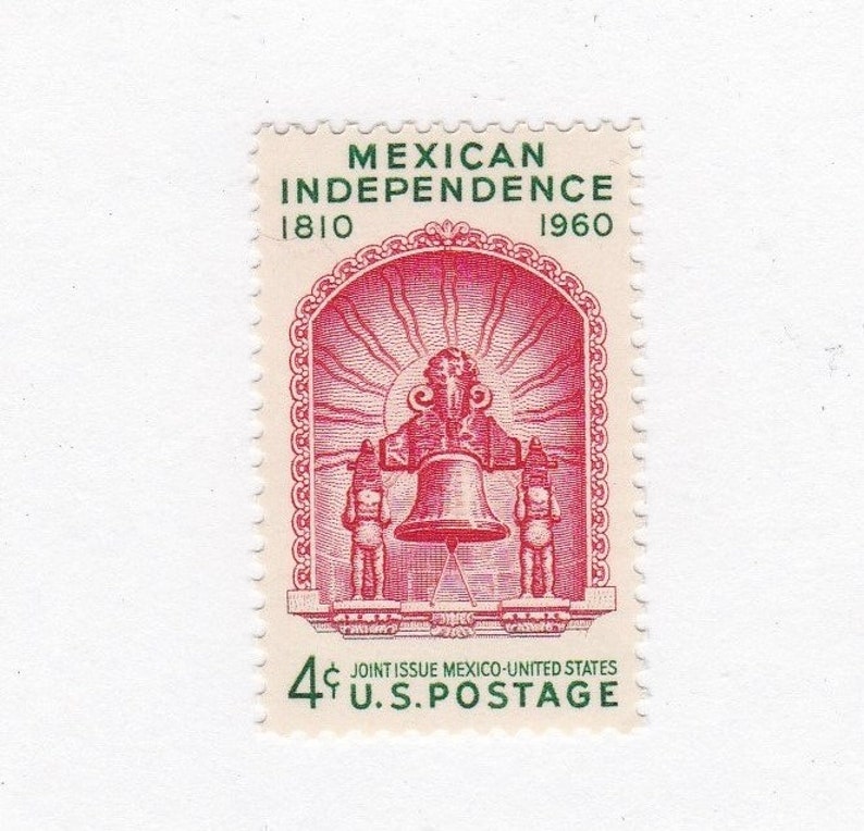 May include: A red and green 4-cent US postage stamp commemorating the 150th anniversary of Mexican Independence. The stamp features a stylized image of a bell with two figures on either side, all within a decorative arch.