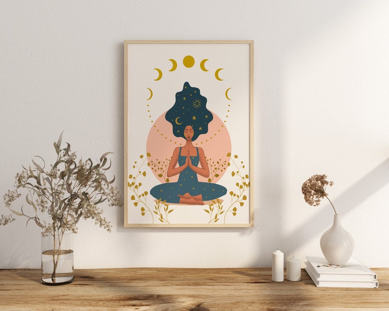 May include: A digital illustration of a woman meditating with her eyes closed. She is sitting in a lotus position with her hands in a prayer position. Her hair is dark blue and filled with stars. The background is a pink circle with gold stars and a crescent moon.