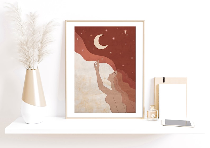 May include: A digital illustration of a woman with long red hair reaching up towards a crescent moon in a starry night sky. The background is a deep red with a soft, flowing cloud.