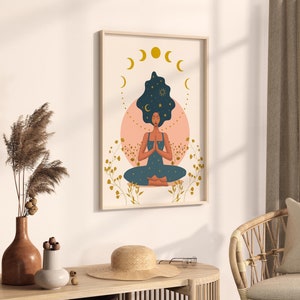 May include: A digital art print featuring a woman meditating with a starry sky in her hair. The print is framed and has a pink and gold color scheme.