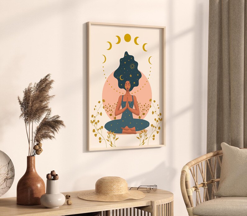 May include: A digital art print featuring a woman meditating with a starry sky in her hair. The print is framed and has a pink and gold color scheme.