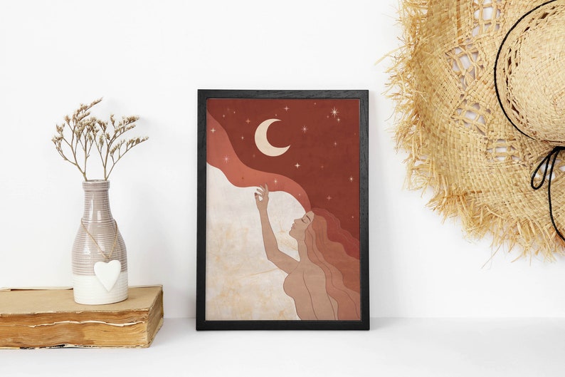 May include: A digital illustration of a woman with long red hair reaching up to touch a crescent moon in a starry night sky. The background is a gradient of red and orange.