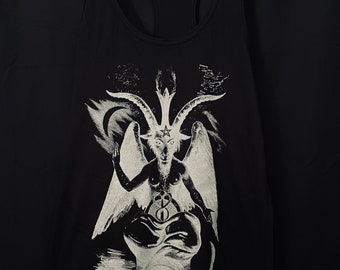 May include: Black tank top with a white graphic of a horned figure with wings, a pentagram, and the text "ROCK N HORROR". The tank top is hanging on a wooden hanger against a black background.