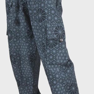 May include: Black cargo pants featuring a repeating geometric starburst pattern in light gray. The pants have an elasticized waistband with a drawstring, side cargo pockets with button closures, and elasticized cuffs at the bottom of the legs.