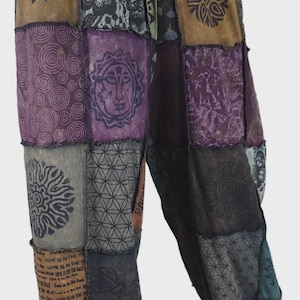 May include: Patchwork trousers in a variety of colours and patterns, including sun faces, floral designs, and geometric shapes. The trousers have a relaxed fit and feature text that reads "LOVE IS IN THE".
