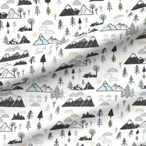 May include: White fabric with a repeating pattern of stylized mountains, trees, and clouds in black, gray, and muted green and blue. The design features various mountain ranges, evergreen trees, and fluffy clouds, creating a whimsical outdoor scene.