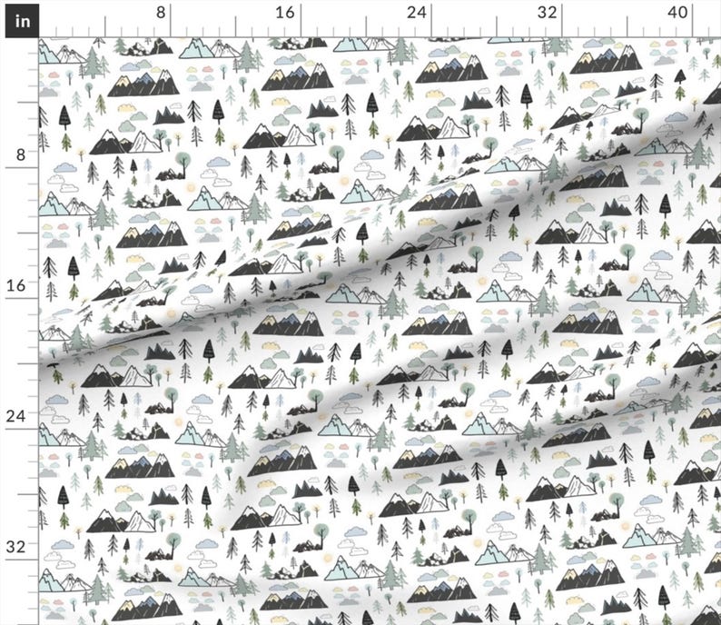 May include: White fabric with a repeating pattern of stylized mountains, trees, and clouds in black, gray, and muted green and blue. The design features various mountain ranges, evergreen trees, and fluffy clouds, creating a whimsical outdoor scene.