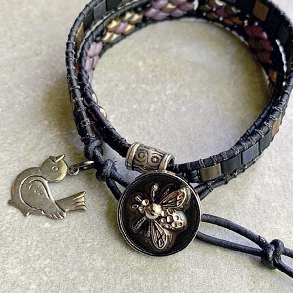 Bee Button on this 2 wrap bracelet with Amethyst, Black and Gold Beads in two different designs separated by a Silver Barrel with Bird Charm