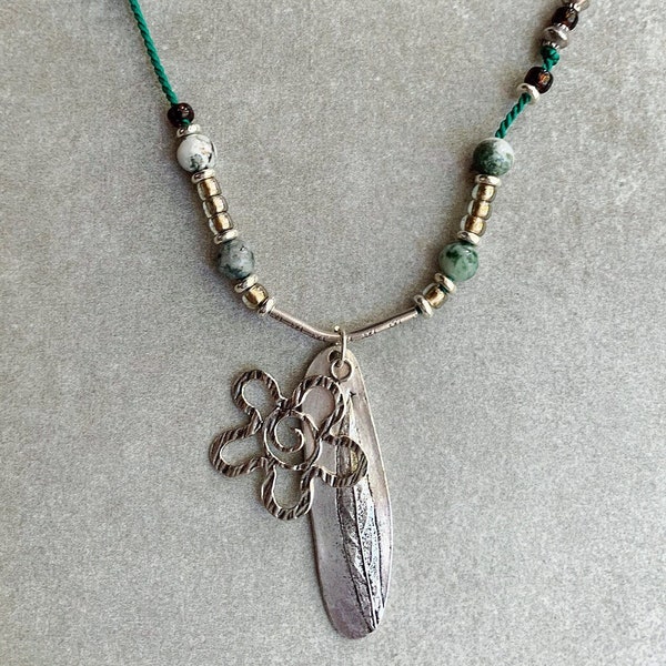 Sterling Silver Flower and stamped Leaf Charms hang from Sterling Tube with different Silver, Agate and Trade Beads on Green Silk Cord