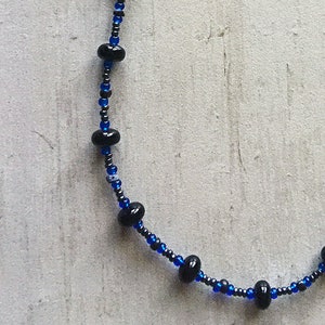 Black Onyx Discs, Vintage Blue Czech Glass, Black and Gray Jasper Barrels & Gray Seed Beads with finish touch of Silver Dolphin at Clasp