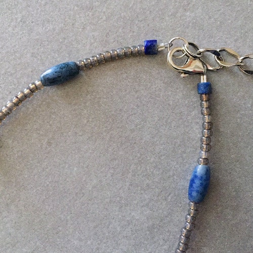 Sterling Silver outlet and Lapis inlaid Dolphin is with Lapis Rounds and Barrels, Dumortierite Stone, Etched Sterling Silver, and Gray Seed Beads