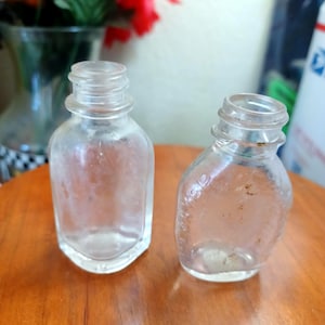 Antique Medicine Bottles, including BAYER and one marked USA with a small Flag, Clear Glass about 2 1/2&quot; ish No Caps/ Lids Collectible