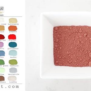 May include: A small white square bowl filled with a red-brown powder. The powder is labeled as "Salem Red" milk paint. The image also shows a color chart with various paint colors and their names.
