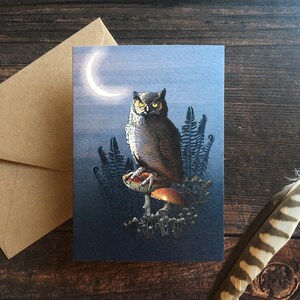 May include: A brown and gray owl with yellow eyes perched on a red and white mushroom in a dark forest setting. The moon is visible in the background.