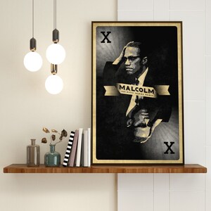May include: A black and white poster with a portrait of Malcolm X. The poster is in the style of a playing card, with the letter 'X' in the top left and bottom right corners. The text 'MALCOLM OUR BLACK SHINING PRINCE' is printed in gold on a banner.