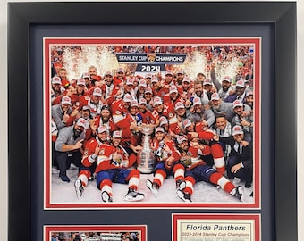 May include: A framed photo of the Florida Panthers hockey team celebrating their 2024 Stanley Cup Championship. The team is holding the Stanley Cup trophy and wearing their red and gold uniforms. The photo includes the team's roster and a summary of their playoff run. The text "Go Panthers!!" is printed at the bottom of the photo.