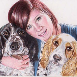 Colour pencil portrait of a woman with two cocker spaniel dogs. One dog is black and white and the other one blond with white. The woman has red / brown hair and wears a blue cardigan and and black and white top. The woman is smiling.