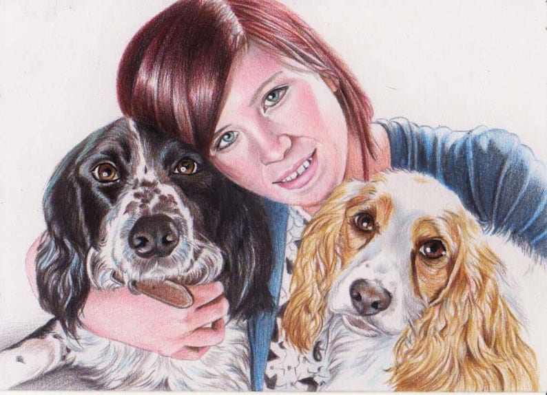Colour pencil portrait of a woman with two cocker spaniel dogs. One dog is black and white and the other one blond with white. The woman has red / brown hair and wears a blue cardigan and and black and white top. The woman is smiling.