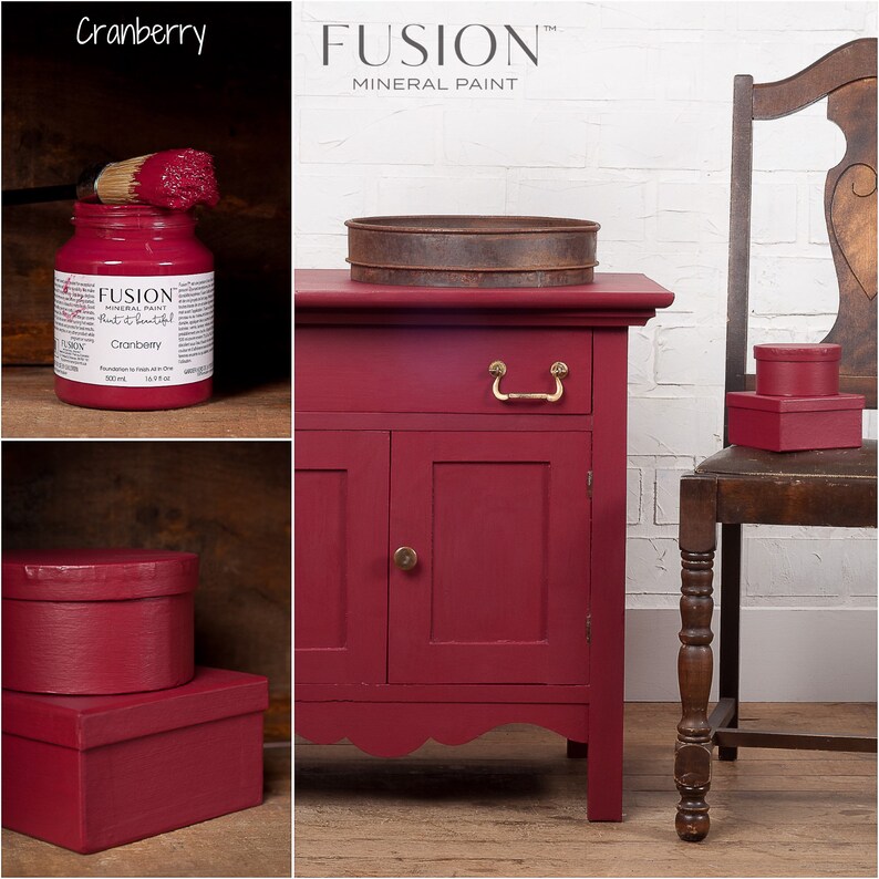 May include: A red painted wooden cabinet with two doors and a drawer. The cabinet has a scalloped bottom edge and brass hardware. The cabinet is painted with Fusion Mineral Paint in the color Cranberry.