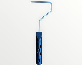 May include: A silver paint roller frame with a black plastic handle. The handle has holes for ventilation.