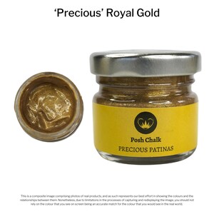 May include: A small jar of gold metallic paint labeled 'Precious Patinas' by Posh Chalk. The jar is open and the paint is visible.