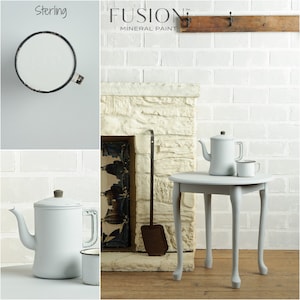 May include: A white brick wall with a fireplace and a small table with two white teapots and a white mug. The text "FUSION MINERAL PAINT" is visible above the fireplace. The paint color is called "Sterling."