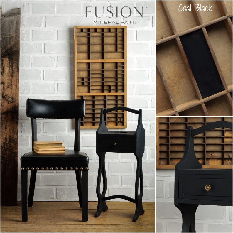 May include: A black side table with a drawer and a curved top rail. The table is painted with Fusion Mineral Paint in the color Coal Black. The table is next to a black chair with a leather seat and nailhead trim. The background is a white brick wall.