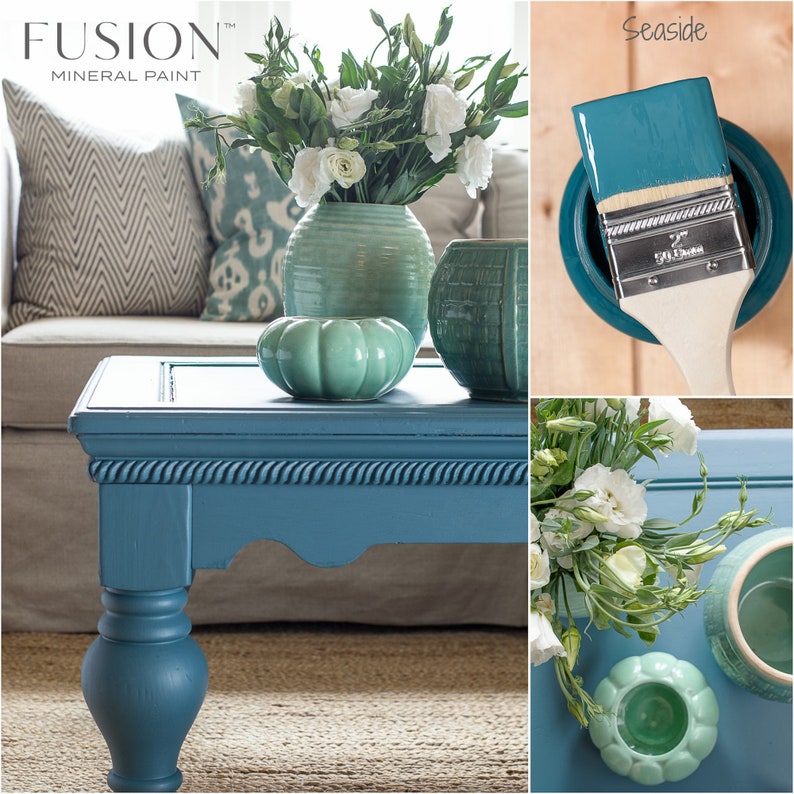 May include: A teal blue coffee table with a rope trim detail, painted with Fusion Mineral Paint in the color Seaside. The table is decorated with a vase of white flowers and three green ceramic pumpkins.