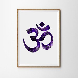 May include: A framed print of the Om symbol in black with a purple watercolor background.