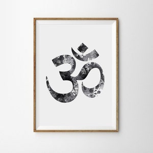 May include: A black and white watercolor print of the Om symbol, a sacred sound in Hinduism and Buddhism, framed in a natural wood frame.