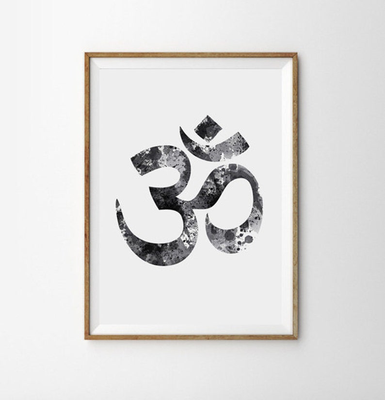 May include: A black and white watercolor print of the Om symbol, a sacred sound in Hinduism and Buddhism, framed in a natural wood frame.