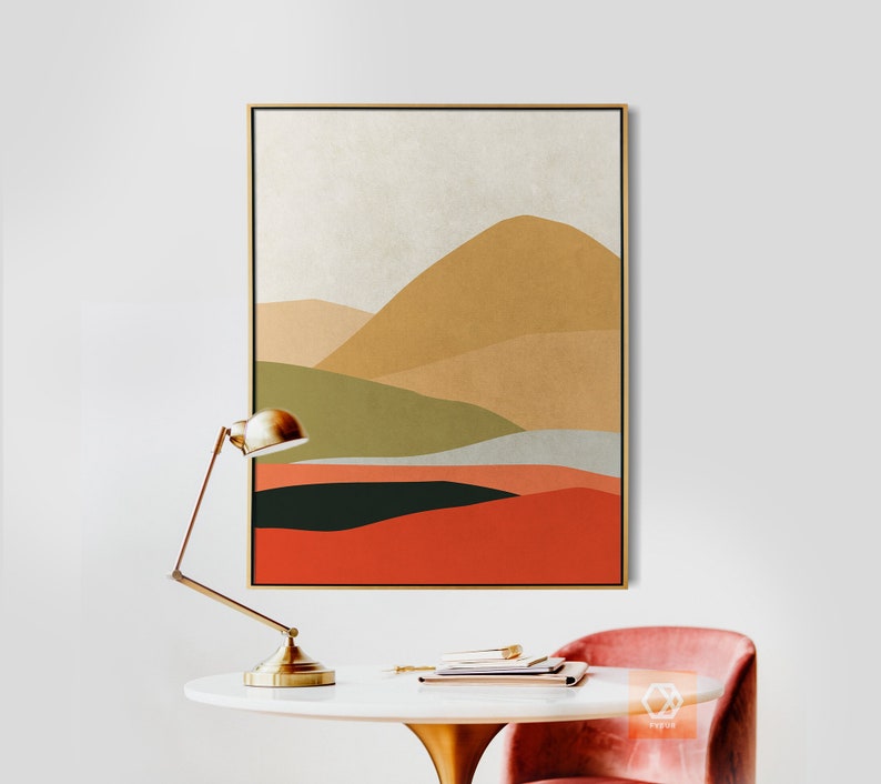 Pu&ograve; includere: Dipinto astratto di paesaggio con cornice dorata. Il dipinto presenta un design a strati di colori verde, marrone, arancione e rosso. Il dipinto &egrave; appeso a una parete bianca sopra un tavolo bianco con una lampada dorata e una sedia rosa.