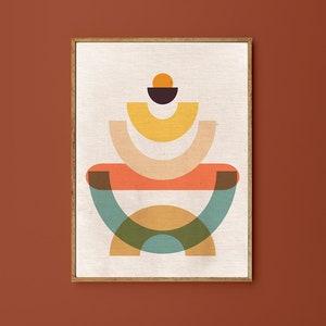 May include: Abstract geometric art print with a layered design of overlapping circles and semi-circles in shades of orange, yellow, green, blue, and brown. The print is framed in a light wood frame.