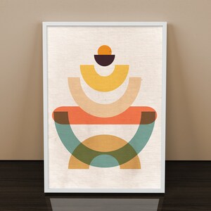 May include: Abstract geometric art print featuring a layered design of overlapping circles and semi-circles in shades of orange, yellow, green, and brown. The print is framed in a white frame.