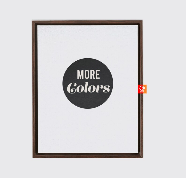 May include: A framed print with a black circle and white text that reads "MORE COLORS" on a white background.