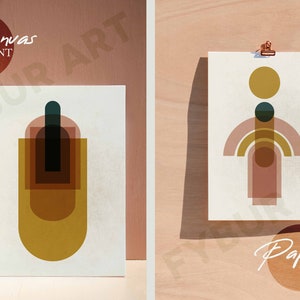 May include: Two abstract geometric art prints, one on canvas and one on paper. The canvas print features a vertical design with overlapping shapes in shades of brown, yellow, and green. The paper print features a horizontal design with overlapping shapes in shades of pink, yellow, and brown.