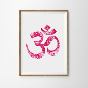 May include: A framed print of a pink watercolor Om symbol, a sacred sound in Hinduism and Buddhism, representing the universe and the divine.