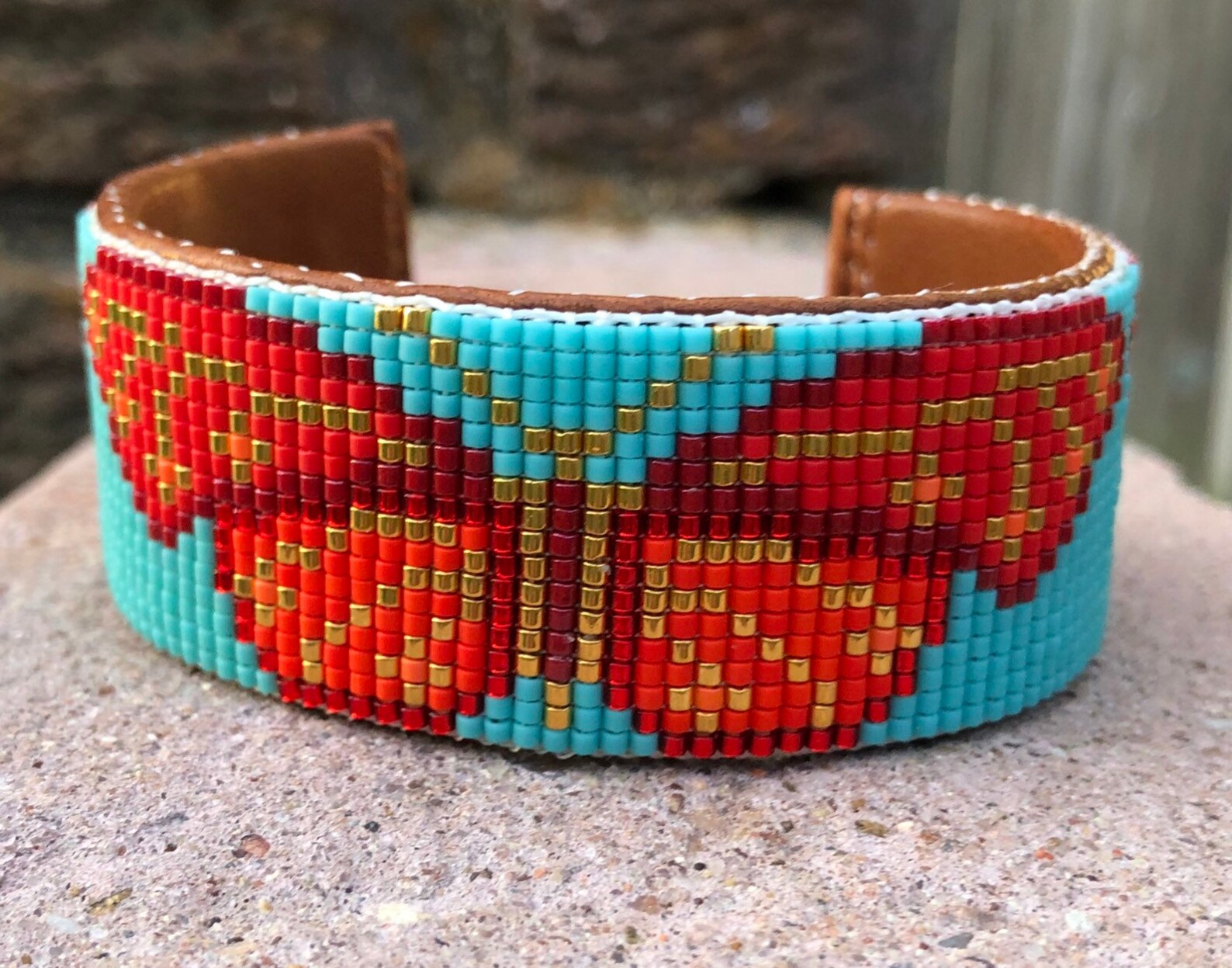 Beaded Butterfly Bracelet in Shades of Reds and Gold on a Turquoise
