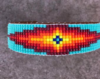 Geometric Beaded Bracelet in Sunburst Colors on a Tuorquise Background. great for Men and Women.