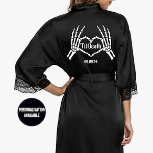 May include: Black satin robe with lace trim and a white skeleton hand heart design on the back. The design includes the text "Til Death" and the date "09.09.24".