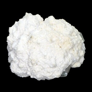 May include: A white, textured mineral specimen against a black backdrop. The mineral has a bubbly, cauliflower-like appearance with a slightly off-white hue. The overall shape is irregular and organic, showcasing natural formations.