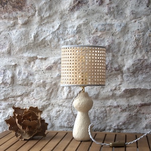 Abstract creamy concrete sculpture table lamp, natural rattan cane lampshade. Unique piece.