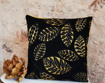 Decorative cushion in jacquard and black and yellow velvet, ethnic foliage from the Thevenon house.