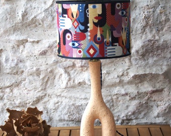 Ceramic vase table lamp, jacquard drum lampshade with abstract female figures.