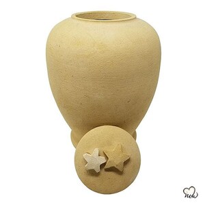 May include: A beige ceramic urn with a lid featuring two white stars. The urn has a smooth, textured surface.