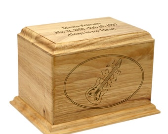 May include: A wooden cremation urn with an engraved electric guitar and musical notes. The urn is inscribed with "Marcus Peterson May 21, 1938 - Feb 18, 1997 Always in my Heart."