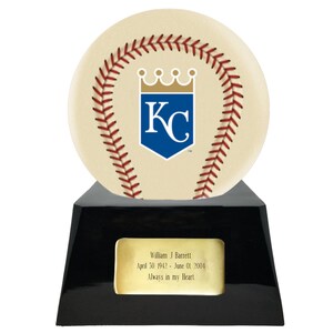 May include: A baseball-themed trophy with a cream-colored baseball design featuring red stitching and a blue and white logo. The trophy sits on a black base with a gold plaque that reads "William J Barrett April 30 1942 - June 01 2004 Always in my Heart."
