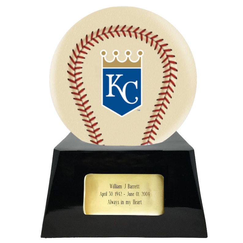 May include: A baseball-themed trophy with a cream-colored baseball design featuring red stitching and a blue and white logo. The trophy sits on a black base with a gold plaque that reads "William J Barrett April 30 1942 - June 01 2004 Always in my Heart."